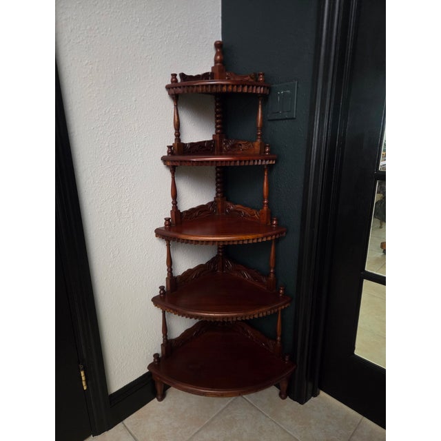A beautifully crafted vintage mahogany corner whatnot shelf, standing 54.5 inches tall and showcasing classic carved...