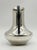 A striking vintage Mexican silver plate water pitcher by Los Castillo of Taxco, distinguished by a sculptural silhouette...