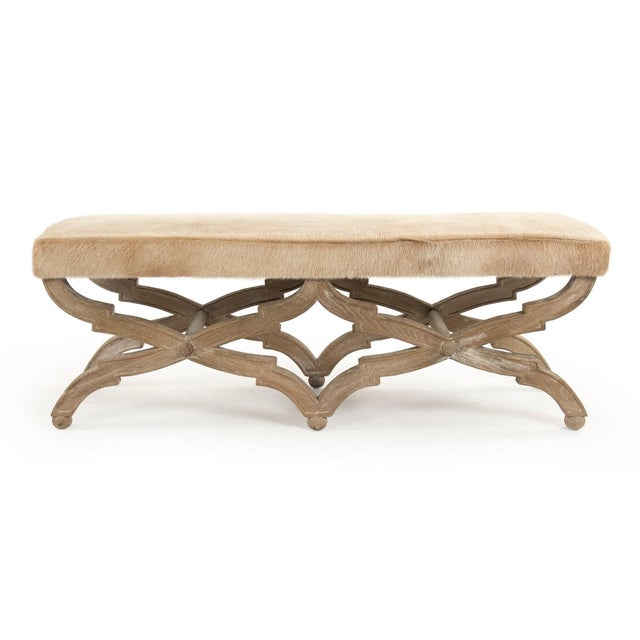 This is a bench featuring a sophisticated design with cowhide upholstery and an oak wood frame. The upholstery showcases a...