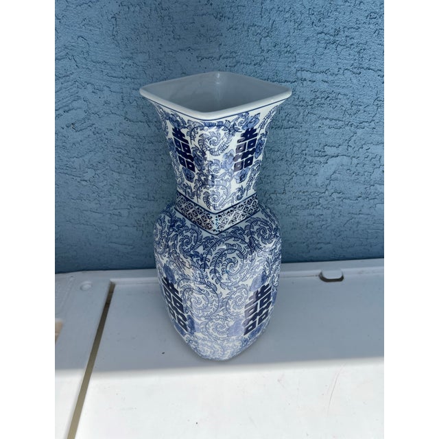 Chinese blue and white porcelain Double Happiness vase. This piece features a squared, angular body that tapers out at the...
