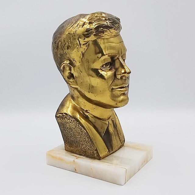 1960s John F. Kennedy JFK bust sculpture in bronze and marble. Made in USA. The sculpture is in excellent condition. So...