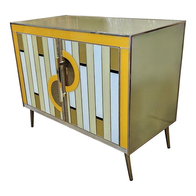 Sideboard with two doors, entirely handmade, with wooden structure and covered in yellow, gold and gray Murano glass;...