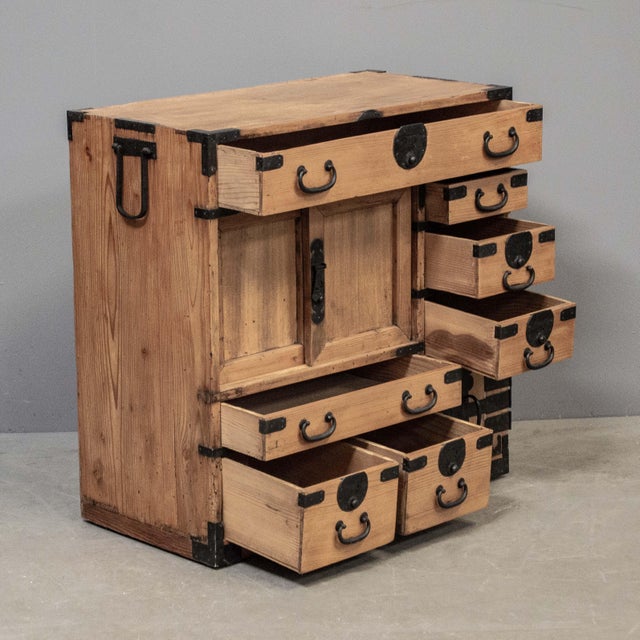 Antique Japanese ”Choba Tansu” merchant chest made of cedar and accented with hand made iron hardware featuring seven...