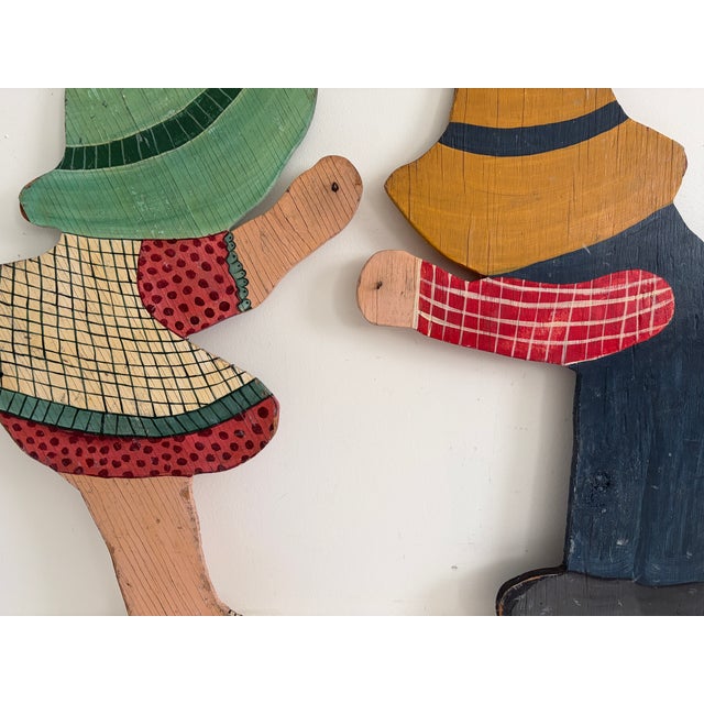 Pair of hand-painted wooden child silhouettes made for garden or yard display. Flat-cut solid wood construction with...
