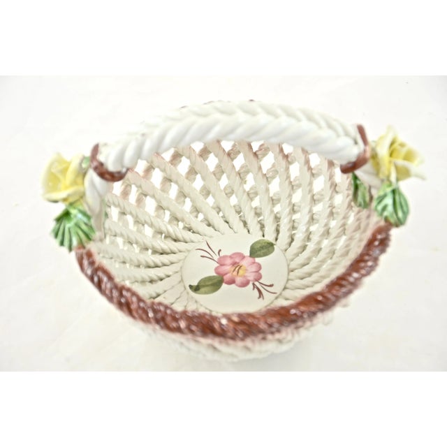 Vintage Italian ceramic Capodimonte handled basket bowl adorned with delicate faience-style spring roses and hand-painted...