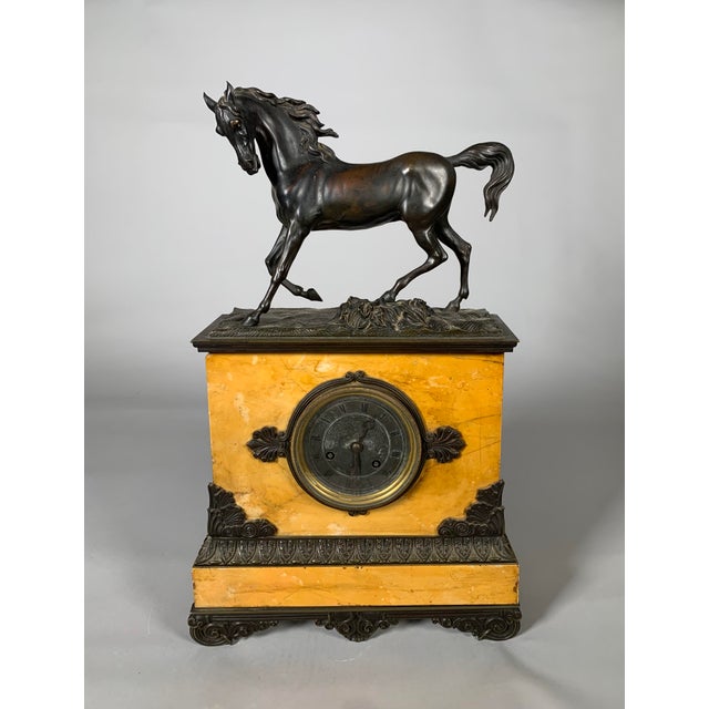 Important mantelpiece set, clock with horse motif and pair of cassolettes in the Charles X Restoration style Siena yellow...