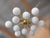 Italian midcentury flush mount with 12 large matte white Murano glass globes mounted on solid brass frame in lacquered...