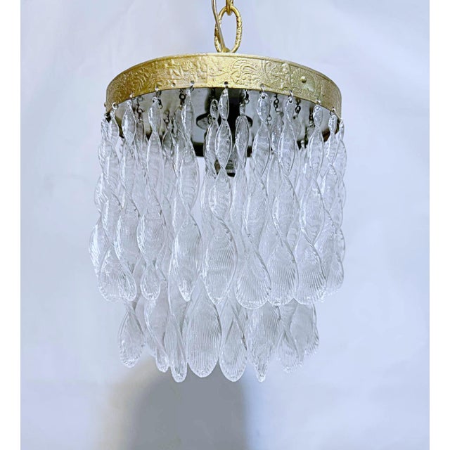 This light fixture is a vintage Murano glass leaf or teardrop chandelier with a small, double-tiered design and a...