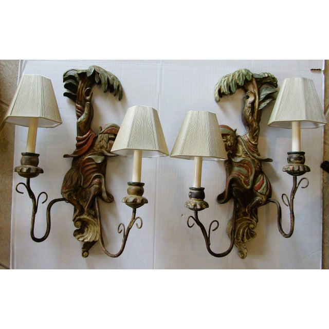 Pair of antique polychrome hand-carved wood and iron monkey wall sconces from the early 20th century. The multicolor...