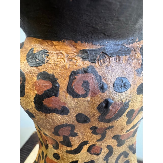 Whimsical and sculptural double-arm table lamp signed by Bill Huebbe , featuring a stylized monkey figure dressed in a...