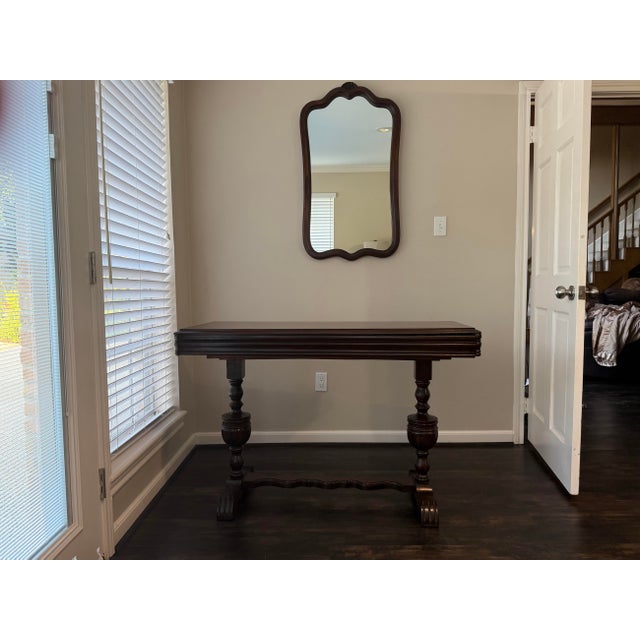 A handsome vintage Jacobean Revival draw-leaf table featuring beautifully turned baluster legs, carved stretcher base, and...