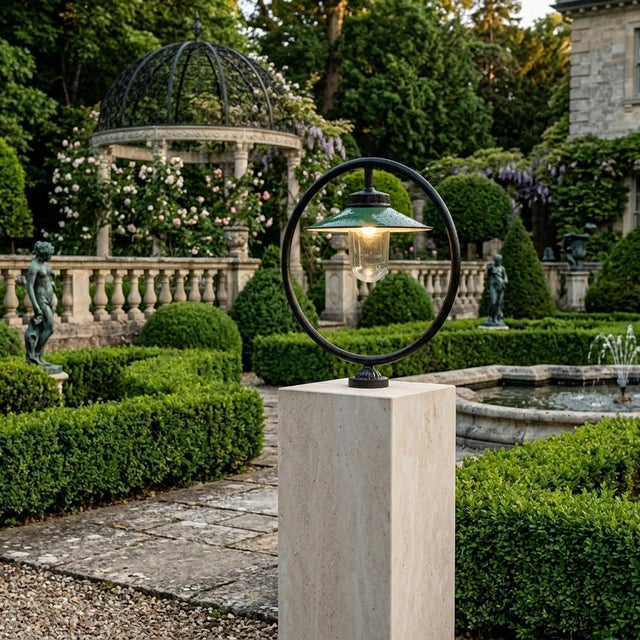 Outdoor lamp featuring a unique circular frame design with a green enameled shade and a protective glass globe. A stylish...