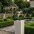 Outdoor lamp featuring a unique circular frame design with a green enameled shade and a protective glass globe. A stylish...
