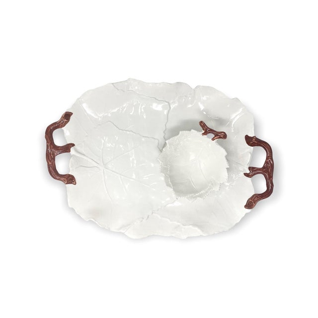 A small leaf-shaped bowl finished with a natural branch handle, hand-painted in Italy. As hand-painted work, expect slight...