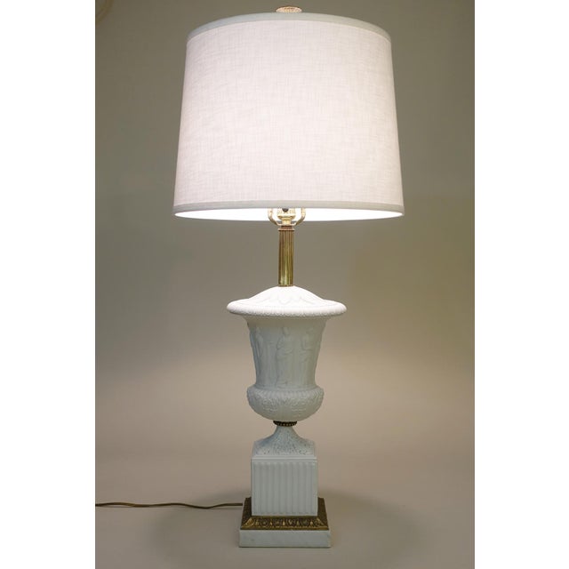 A bold and impressive stylized Neoclassical Modern Bisque, Marble & Brass table lamp designed and manufactured by Paul...