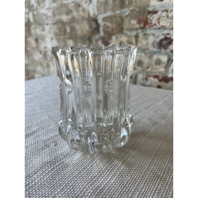 This beautifully sculpted clear glass vessel features vertical ribbing with a unique bubble-dot design and fluted,...