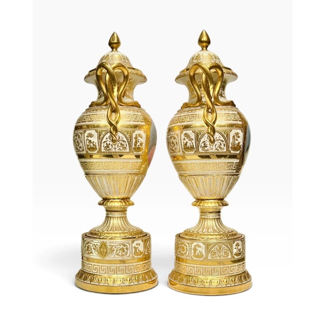 pair of antique Royal Vienna porcelain vases in the neoclassical style, circa 1890s-1900s, feature exceptional gilt...