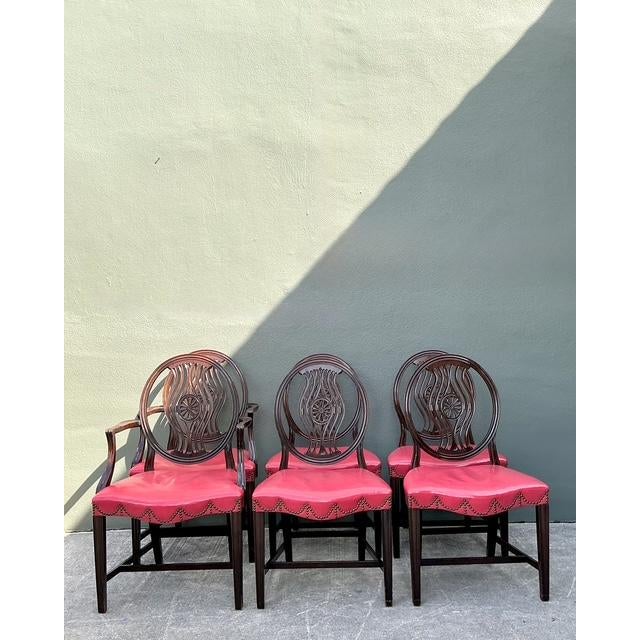 This sophisticated set of six Hepplewhite-style dining chairs exudes timeless elegance and neoclassical charm. Crafted...
