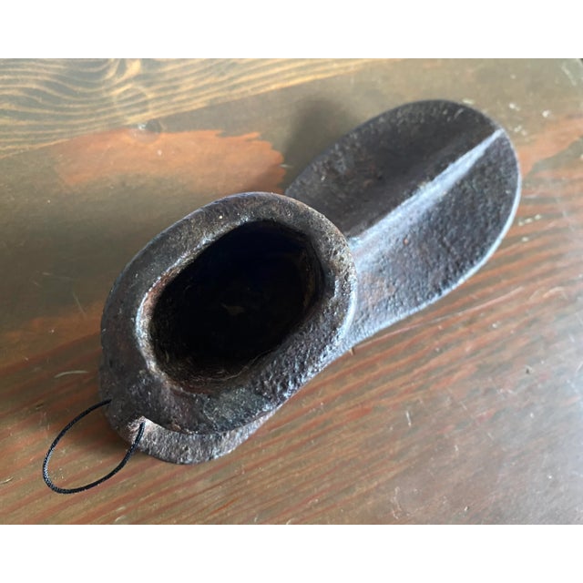 Iron antique cobbler’s shoe last. Great paperweight, or to add into a gallery wall for a whimsical twist!
