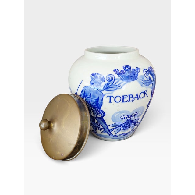 An elegant and highly decorative dutch delft blue tobacco jar, dating from circa 1950s–1960s, featuring richly detailed...