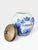 An elegant and highly decorative dutch delft blue tobacco jar, dating from circa 1950s–1960s, featuring richly detailed...