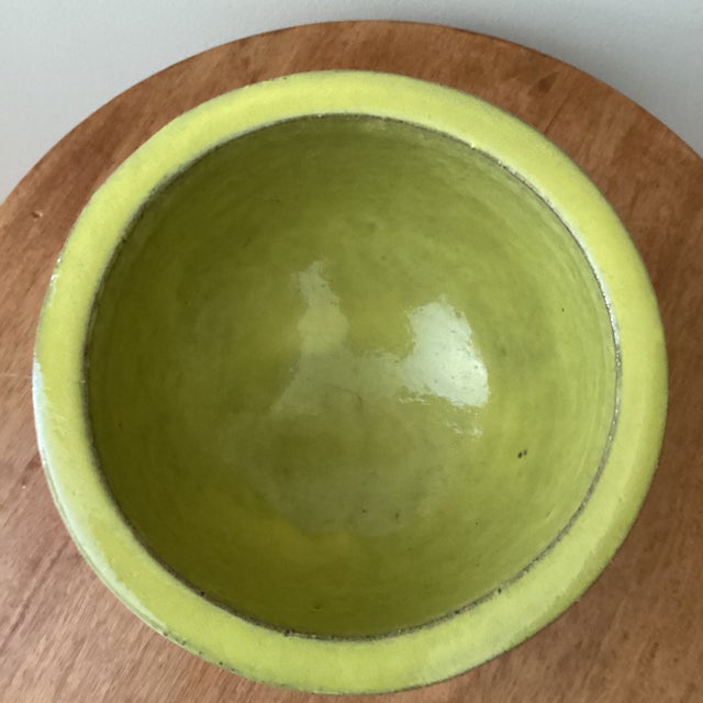 This mid 20th century modern lime glazed art pottery footed pedestal vase/vessel is a stunning representation of the mid-...