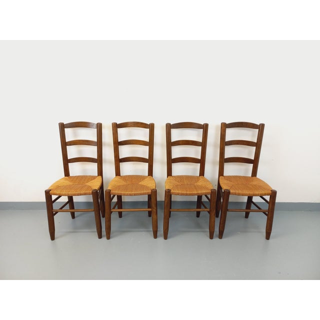 Four vintage Brutalist chairs from the 1960s, rustic chalet style. Made of wood with straw seats. Very good overall...