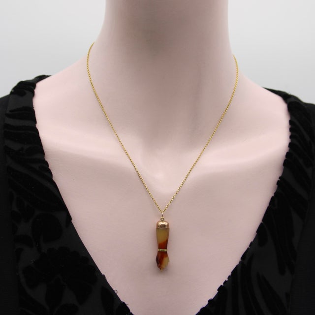 Circa the 1920’s, this celluloid Figa is beautifully carved with 9k gold detailing and a 14k gold bail. The celluloid is a...