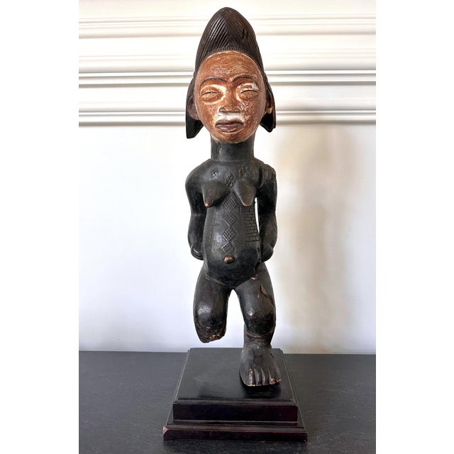 On offer is a Punu ancestor female figure presented on a custom stand circa first half of 20th century. Statue of full...