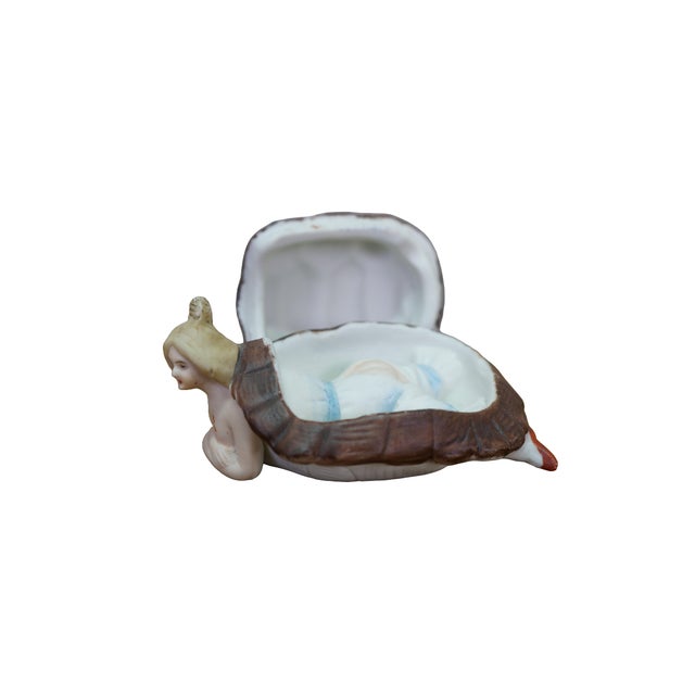 Antique German porcelain bathing beauty trinket box, often called a naughty lady figure, featuring a woman emerging from a...