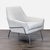 Contemporary West Elm lounge chair featuring clean mid-century inspired lines, tailored oatmeal upholstery, and polished...