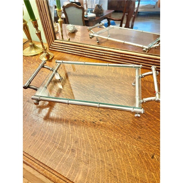 Attributed to Duchin, this faux bamboo silver plate tray was a popular item in the 1960’s. The glass surface sits on a...
