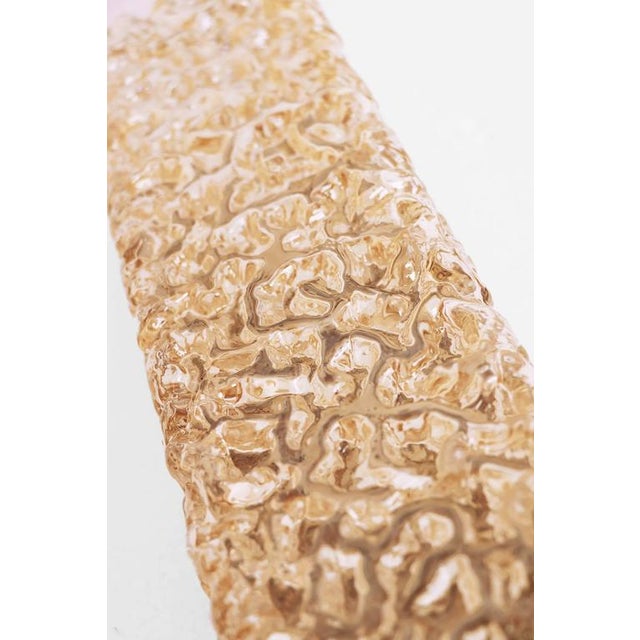 Elegant set of three wall sconces made of textured amber glass on a brass frame. Designed by helena tynell. Manufactured...