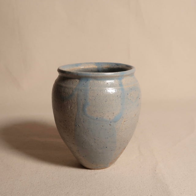 A beautifully restrained signed studio pottery vase featuring a classic, softly rounded form with a gently flared rim and...