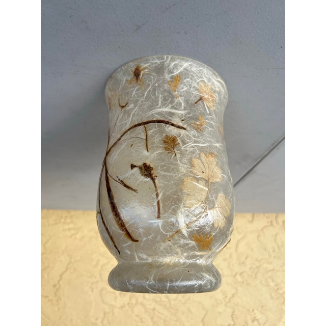Vintage Glass vase signed on the bottom. It features a unique, textured appearance created by the embedded natural...