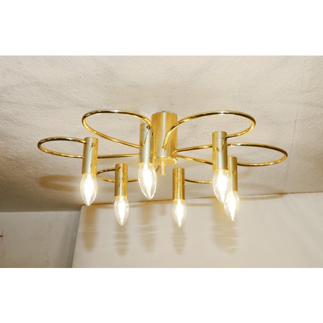 Designer ceiling lamp Designer ceiling lamp made around 1970. Six lights. Curved brass tubes and sockets. The lamp has...