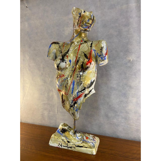 This resin sculpture, created by artist Silvio Formichetti, features a stylized female bust that combines the strength of...