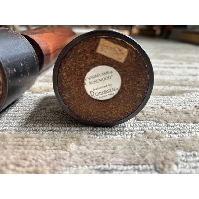 A mid-century pair of Danish style Ronson Rosewood Varaflame Candlesticks, made in 1964 with heavy iron weighted bases...