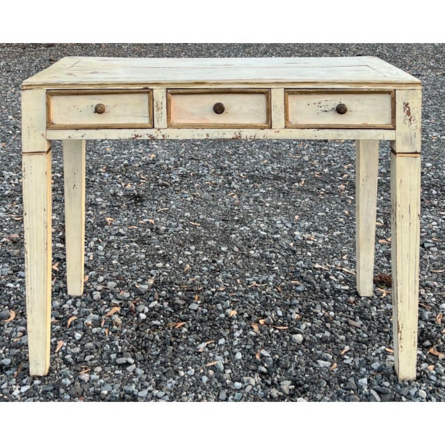Charming vintage Gustavian style console table with three drawers. Character abounds in this rustic piece with lots of...