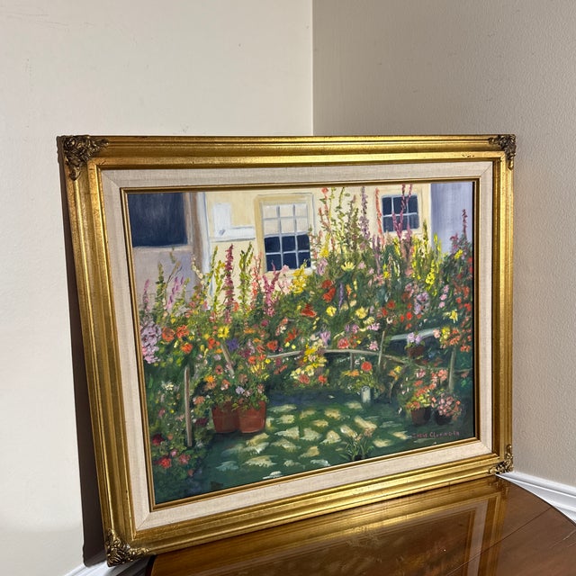 stunning original oil painting by artist Irene Cloninger. This piece captures a vibrant, sun-drenched garden bursting with...