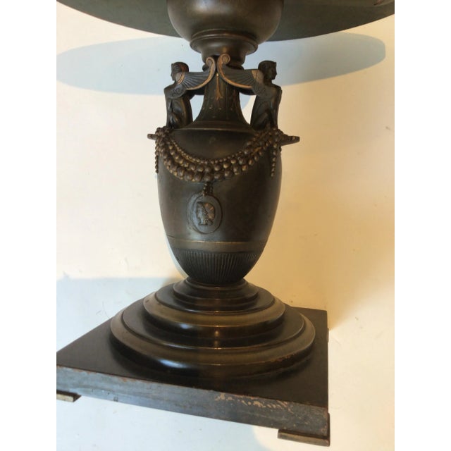 1880s Bronze classical urn made into a side table in the 1950s. Wood base and top.