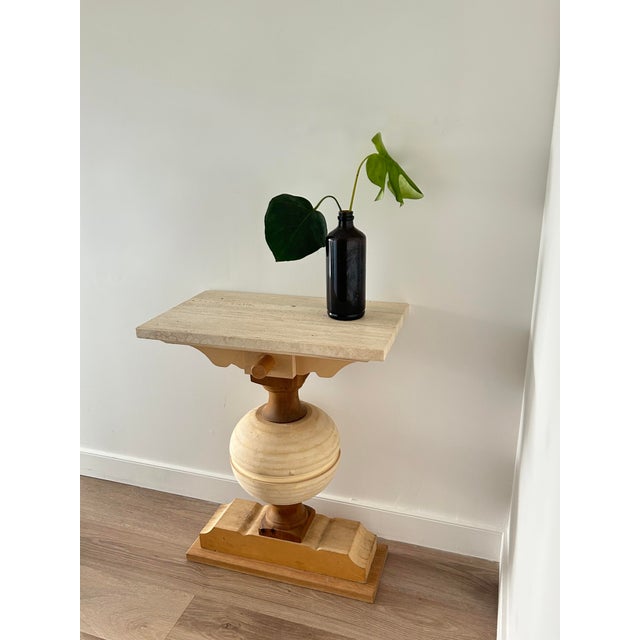 Self made console table with a travertine top and a wooden base which was once a mockup of a table leg, combination of...