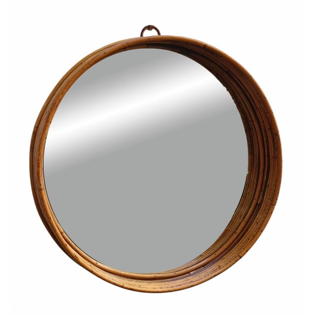 Round wall mirror with a majestic, deep frame crafted from natural bamboo canes. The sculptural, geometric design and the...