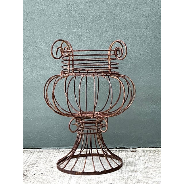 This vintage sculptural metal urn brings a strong architectural accent to a garden, entry, or interior setting. Crafted...