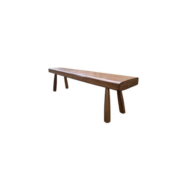 This solid teak wood bench is a study in understated craftsmanship, where refined detailing and natural materiality come...