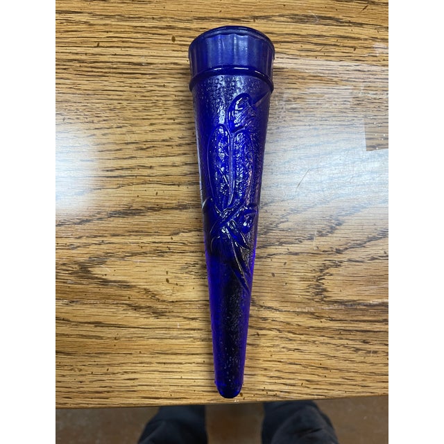 Add a striking pop of color and history to your home with this stunning cobalt blue Dugan glass wall pocket vase....