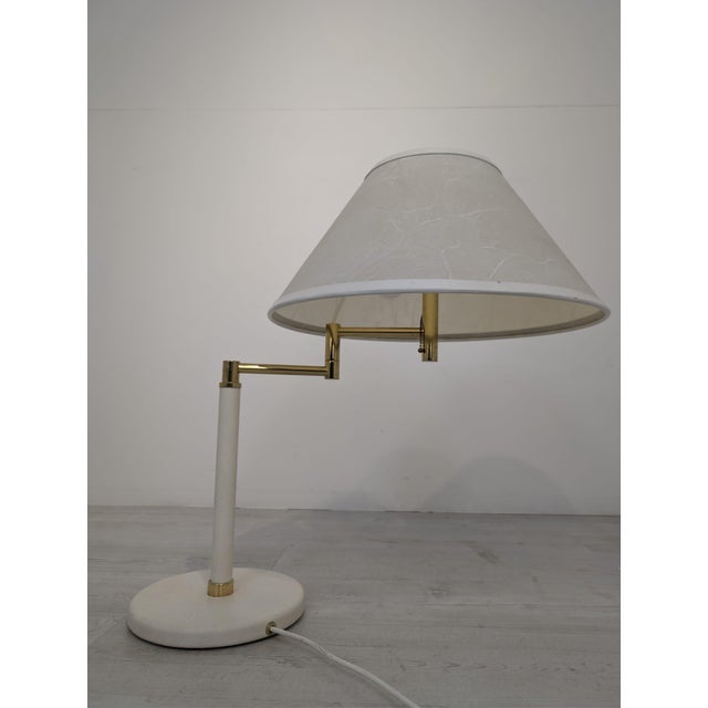 Hollywood Regency Brass Table Lamp Stylish Hollywood Regency brass table lamp. The lampshade resembles white marble. The...