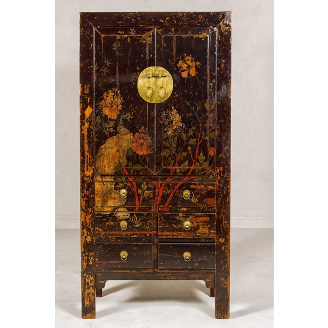 A Qing Dynasty period hand-painted cabinet from the 19th century with hand-painted floral décor, two doors and six...