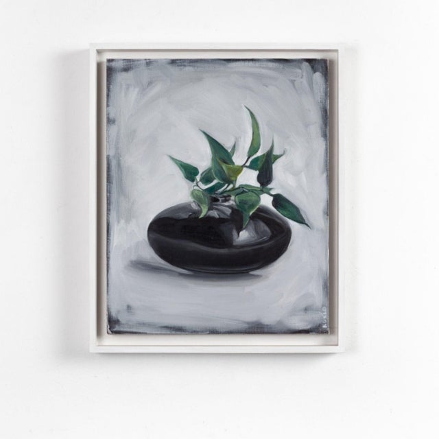 About the painting: this striking artwork showcases a luscious green plant elegantly emerging from a glossy, dark, oval...