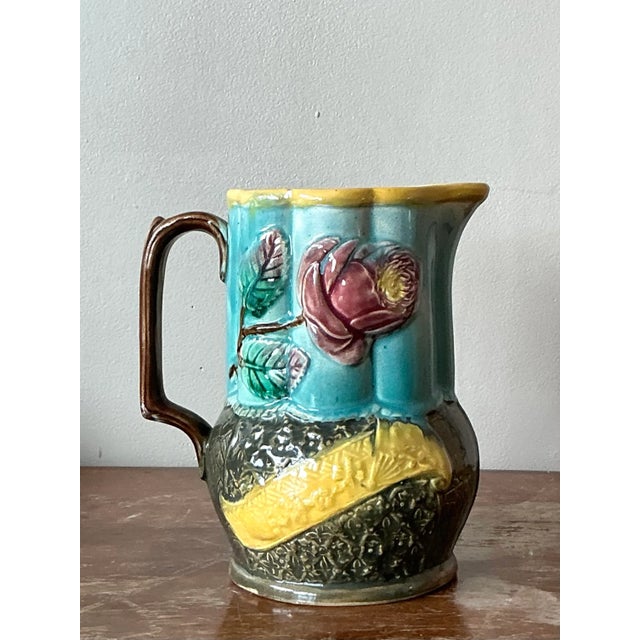 A fascinating and highly artistic example of late Victorian ceramics, this antique majolica pitcher is a masterpiece of...